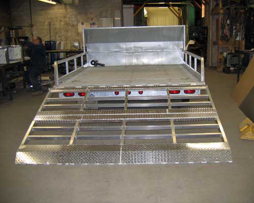 Snowmobile trailer for NS Power . Holds 2 sleds or two 4-wheelers. features bi-fold aluminum ramp at rear.
